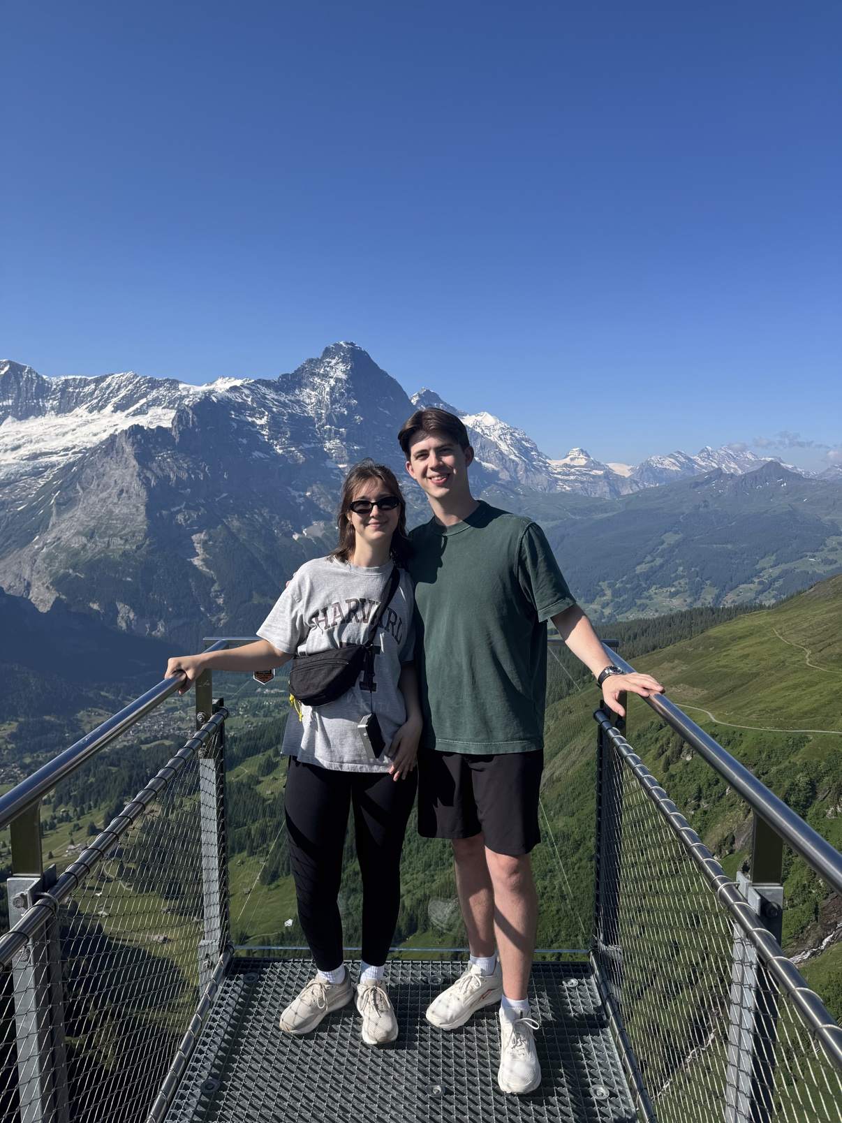 Two people standing on the First Cliff Walk above Grindelwald, the Eiger rising behind them
