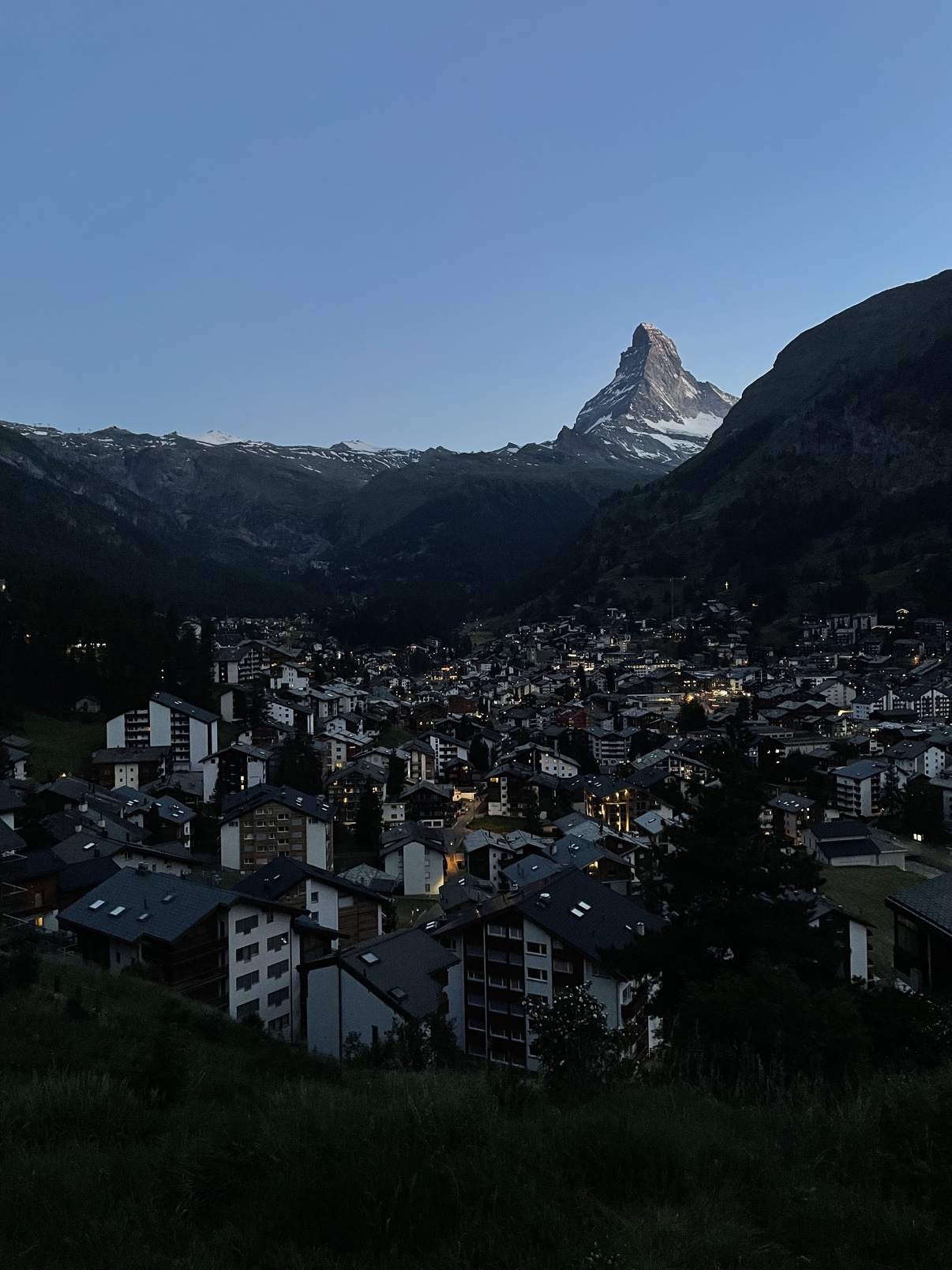 Zermatt village at dusk with the Matterhorn looming above it